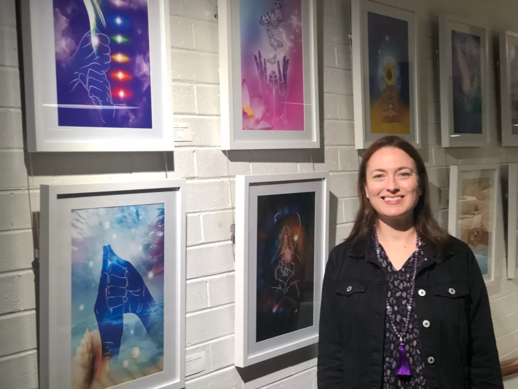 Emma Wertheim at Quintessence art exhibition in front of mudra art